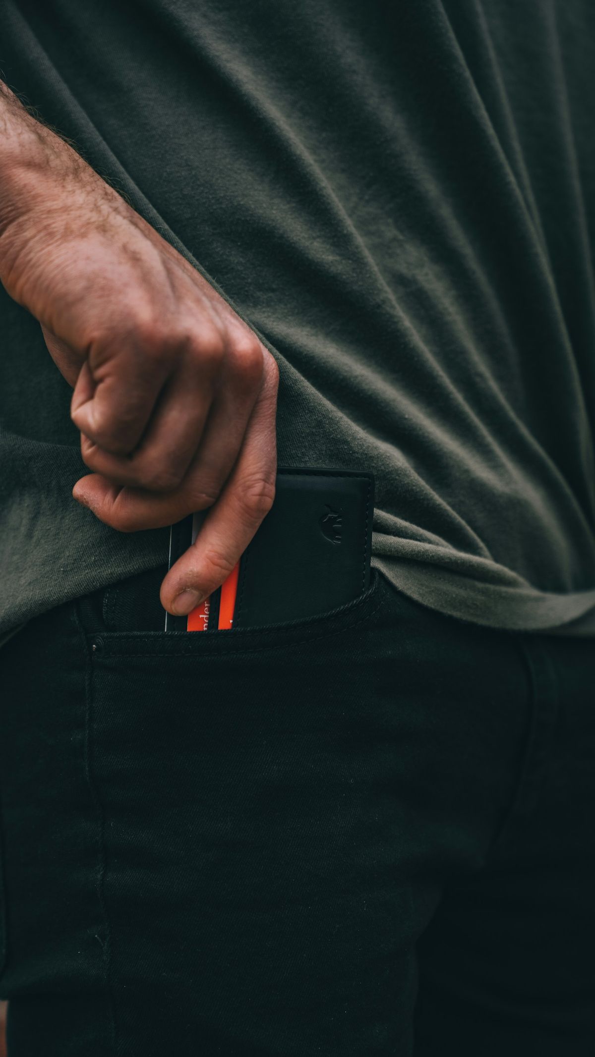 Black leather duty belt held in hand